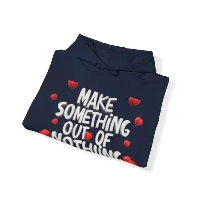Navy blue hoodie with 'Make Something Out of Nothing' text and red heart accents, folded.