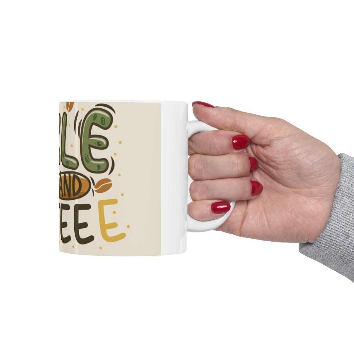 Hand holding ceramic coffee mug with playful pickleball and coffee text design